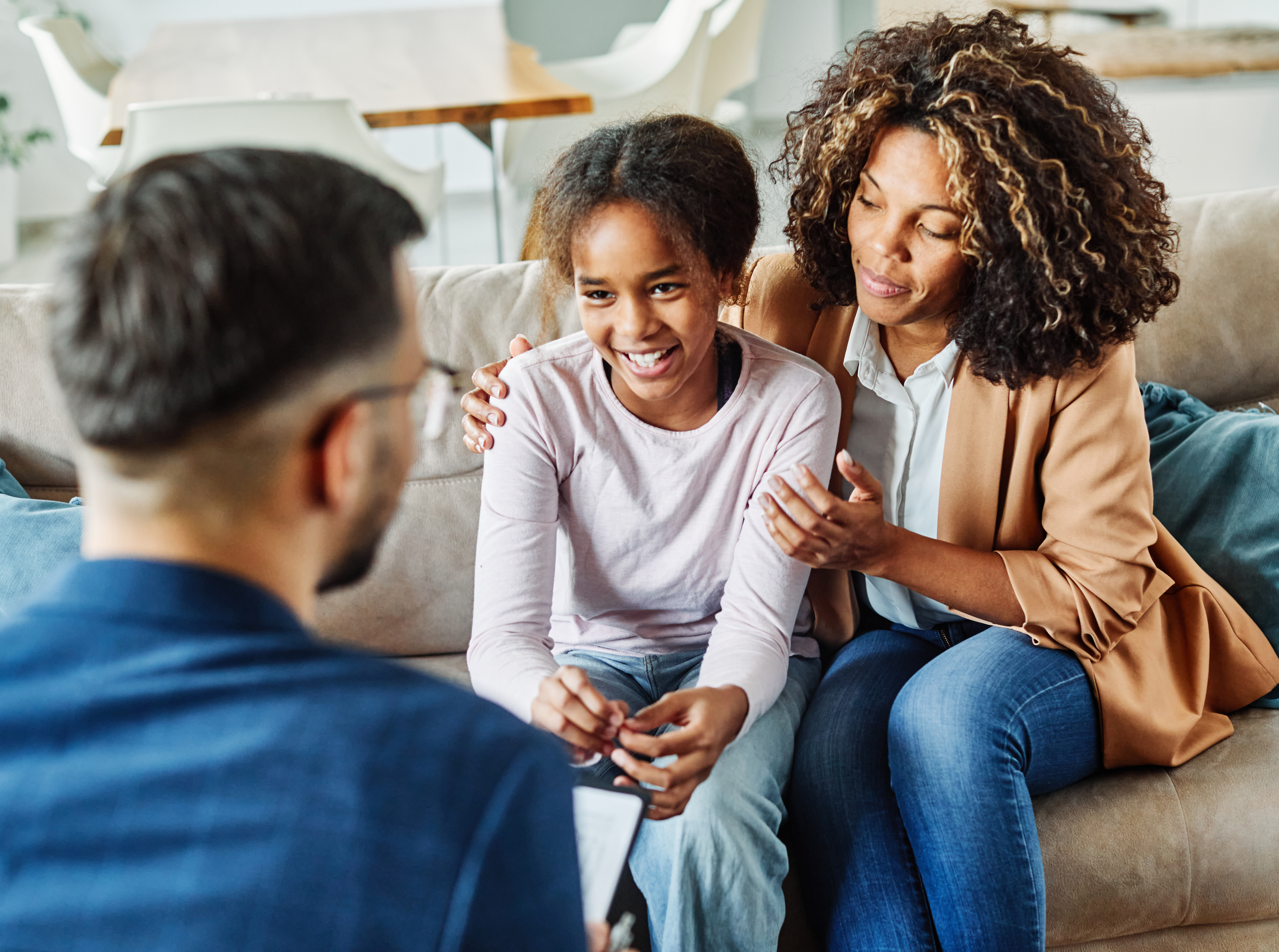 Mom and daughter with male therapist