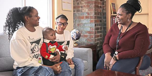 Social services worker with mother and children at their home